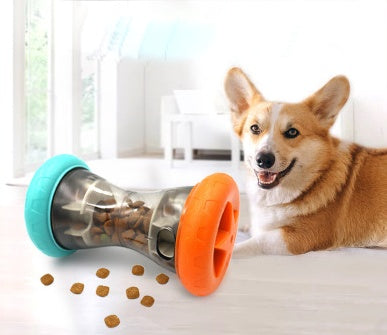 Happy dog by interactive treat dispenser toy with scattered kibble on floor in bright room
