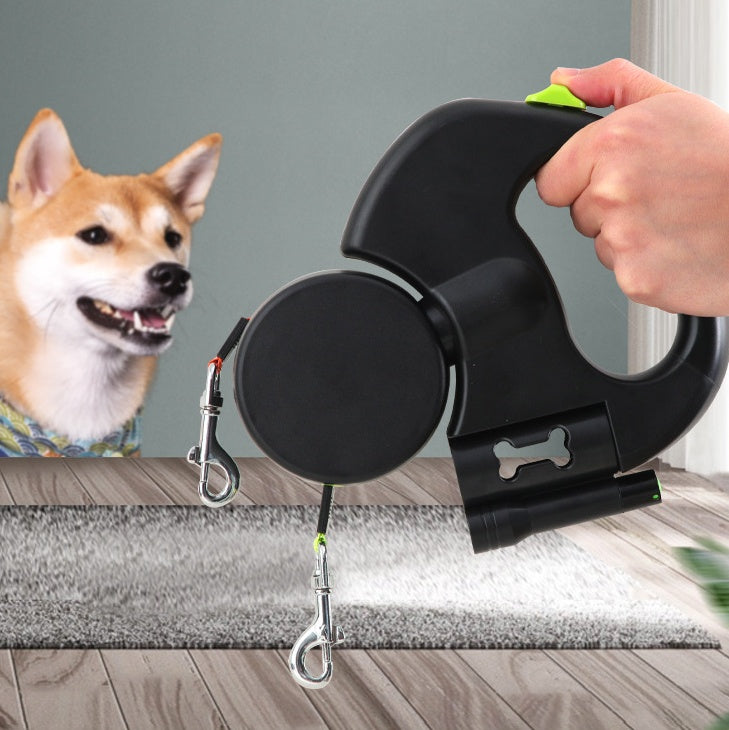 Retractable dual dog leash with flashlight, held in hand, Shiba Inu in background, indoor setting