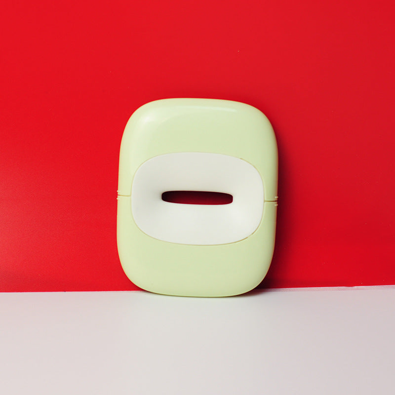 Modern green pet grooming tool with white handle on red background