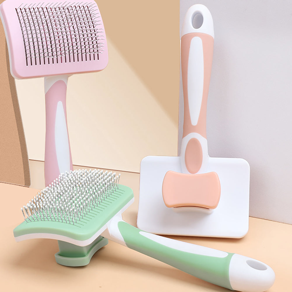 Assorted pet grooming brushes with ergonomic handles in pastel colors on a beige background